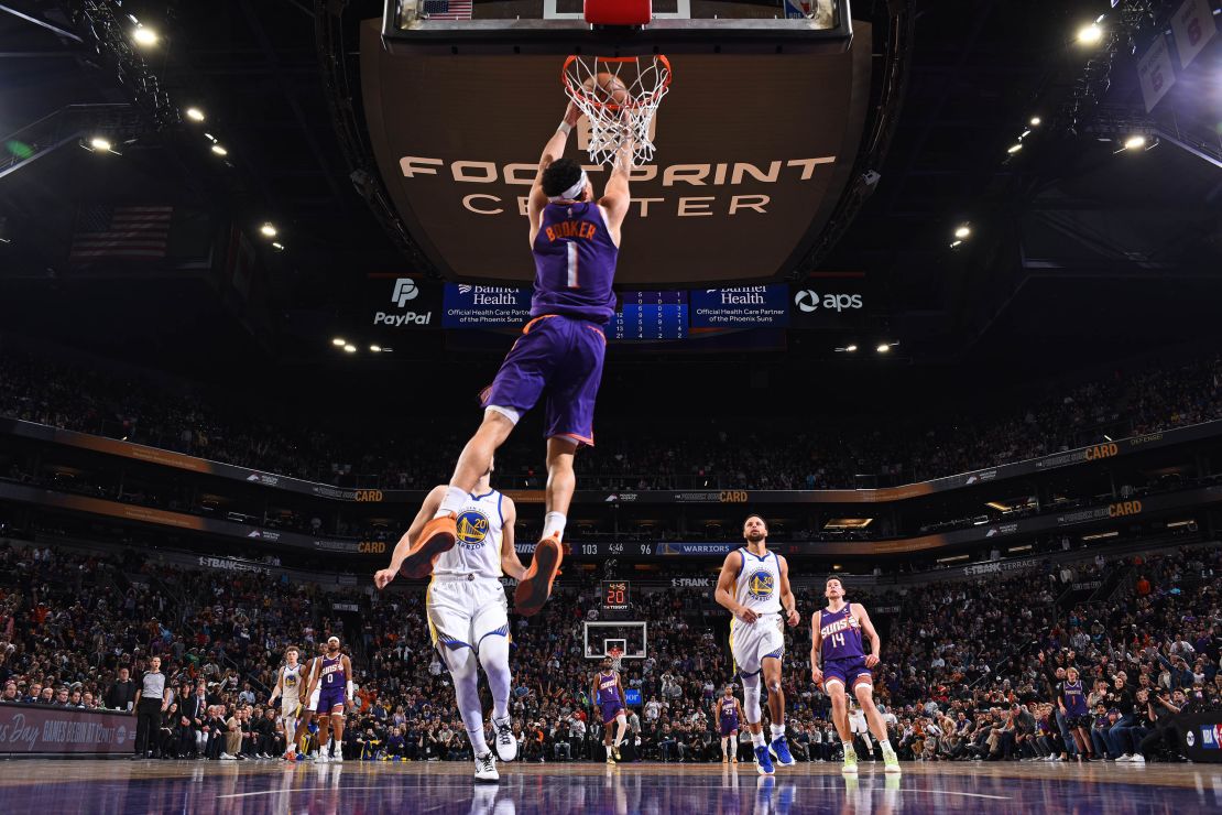 PHOENIX, AZ - DECEMBER 12: Devin Booker #1 of the Phoenix Suns dunks the ball during the game against the Golden State Warriors on December 12, 2023 at Footprint Center in Phoenix, Arizona. NOTE TO USER: User expressly acknowledges and agrees that, by downloading and or using this photograph, user is consenting to the terms and conditions of the Getty Images License Agreement. Mandatory Copyright Notice: Copyright 2023 NBAE (Photo by Garrett Ellwood/NBAE via Getty Images)