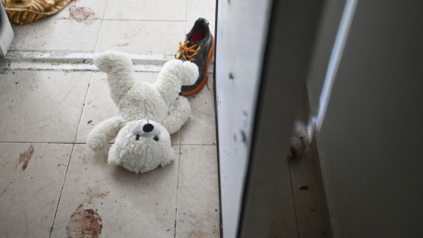 HOLIT, ISRAEL - NOVEMBER 01: A teddy bear is seen left on the ground near the bomb shelter of a kibbutz home attacked by Hamas on Oct 7th, near the border with Gaza, on November 01, 2023 in Holit, Israel. According to an IDF officer, two grandparents who resided here held the bomb shelter door closed during the attack to protect their grandchildren. All were injured but survived. (Photo by Alexi J. Rosenfeld/Getty Images)