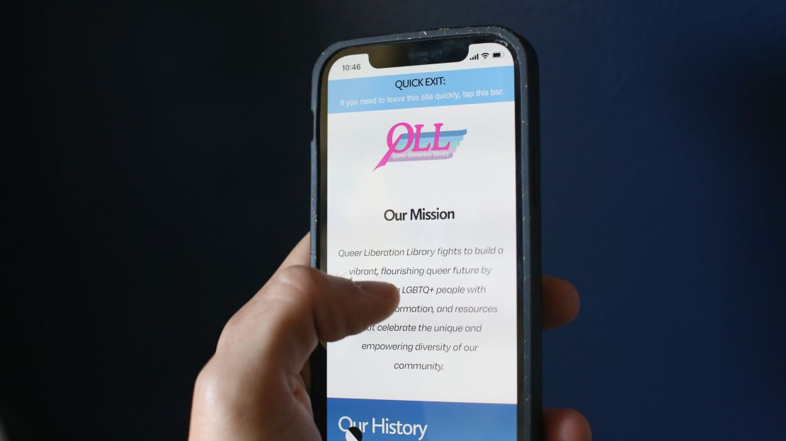 The Queer Liberation Library site is seen on a phone.