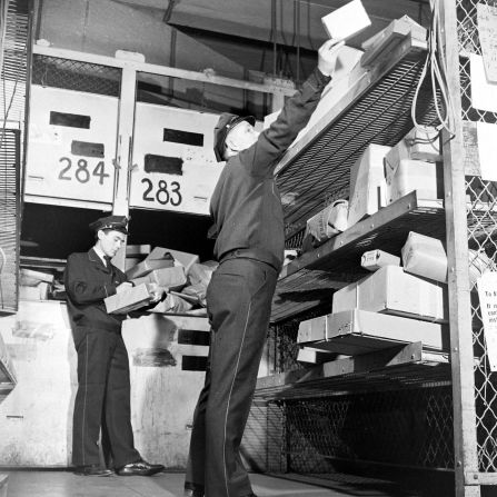Workers sort parcels at a Macy's store circa 1942.
