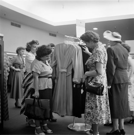 People look at Macy's version of actress Rita Hayworth's wedding dress in 1949.