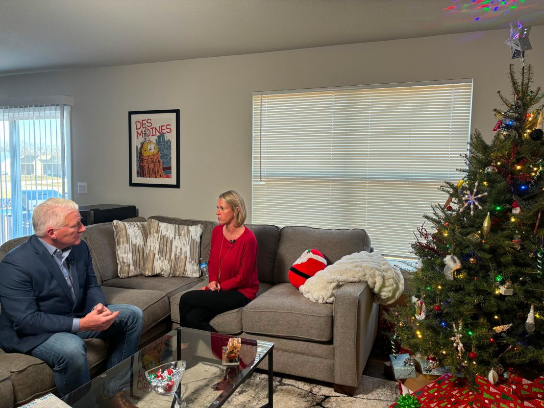 John King sits with Iowa voter Jaclyn Taylor in Waukee, Iowa, in December.