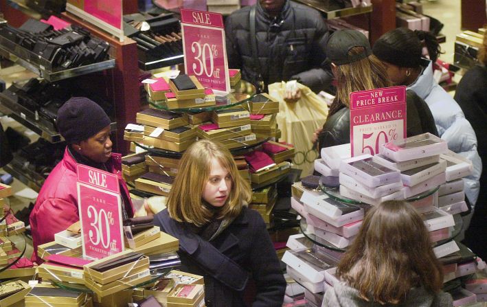 Shoppers browse through sale aisles in New York in 2000.