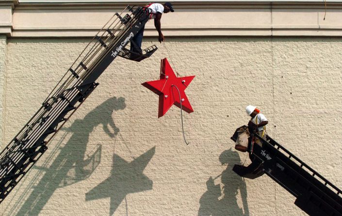 Workers install a Macy's sign at the site of a former Hecht's at the Cross Creek Mall in Fayetteville, North Carolina, in 2006.
