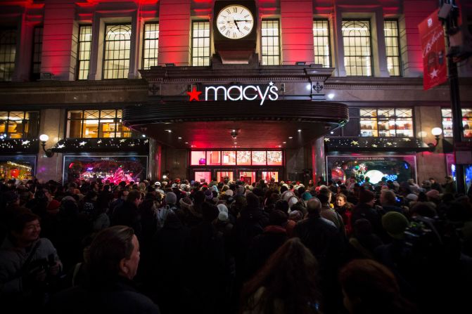 Black Friday shoppers wait to enter a Macy's in New York in 2014.
