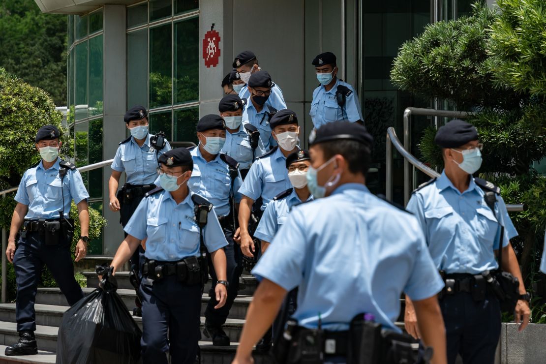 HONG KONG, CHINA - JUNE 17: Police carry evidence they sized from the headquarters of the Apple Daily newspaper and its publisher Next Digital Ltd. on June 17, 2021 in Hong Kong, China. Hong Kong's national security police raided the office of Apple Daily, the city's fierce pro-democracy newspaper run by media magnate Jimmy Lai, in an operation involving more than 200 officers. Journalists were barred from their own offices, as Secretary for Security John Lee said the company used