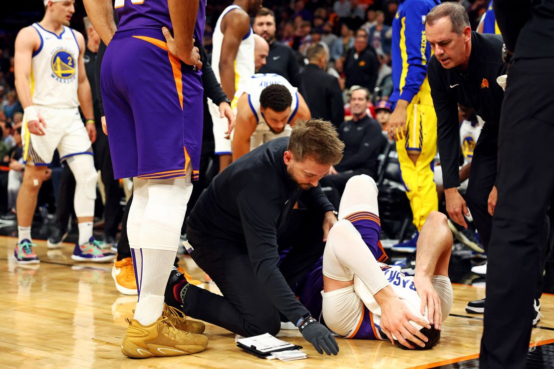 Dec 12, 2023; Phoenix, Arizona, USA; Phoenix Suns center Jusuf Nurkic (20) lays on the court after being fouled by Golden State Warriors forward Draymond Green (not pictured) during the third quarter at Footprint Center. Mandatory Credit: Mark J. Rebilas-USA TODAY Sports