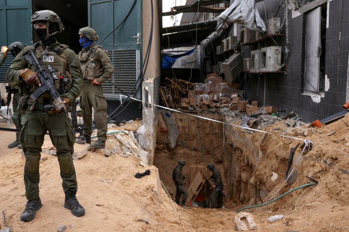 Israeli soldiers stand near the opening to a tunnel at Al Shifa Hospital compound in Gaza City, amid the ongoing ground operation of the Israeli army against Palestinian Islamist group Hamas, in the Gaza Strip, November 22, 2023.