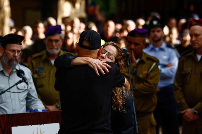 Mother and father of Israeli military commander Major Ben Shelly, who was killed in northern Gaza, embrace each other at his funeral in Kidron, Israel, on December 14.