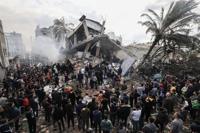 Palestinians gather around the destroyed Shehada family home following Israeli bombardment of Rafah, Gaza, on December 14.