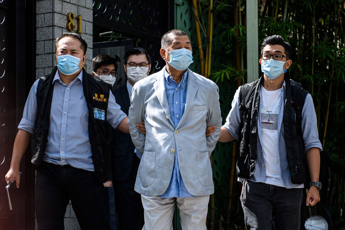 TOPSHOT - Police lead Hong kong pro-democracy media mogul Jimmy Lai (C), 72, away from his home after he was arrested under the new national security law in Hong kong on August 10, 2020. - Hong Kong pro-democracy media mogul Jimmy Lai was arrested under a new national security law on August 10 and police raided his newspaper offices in a deepening crackdown on dissent in the restless Chinese city. (Photo by VERNON YUEN / AFP) (Photo by VERNON YUEN/AFP via Getty Images)