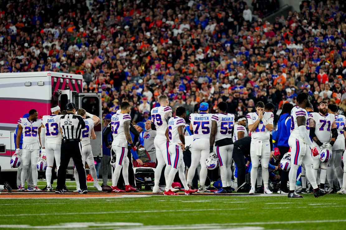 Jan 2, 2023; Cincinnati, Ohio, USA; The Buffalo Bills gather as an ambulance parks on the field while CPR is administered to Buffalo Bills safety Damar Hamlin (3) after a play in the first quarter of the NFL Week 17 game between the Cincinnati Bengals and the Buffalo Bills at Paycor Stadium. The game was suspended with suspended in the first quarter after Buffalo Bills safety Damar Hamlin (3) was taken away in an ambulance following a play. Mandatory Credit: Sam Greene-USA TODAY Sports