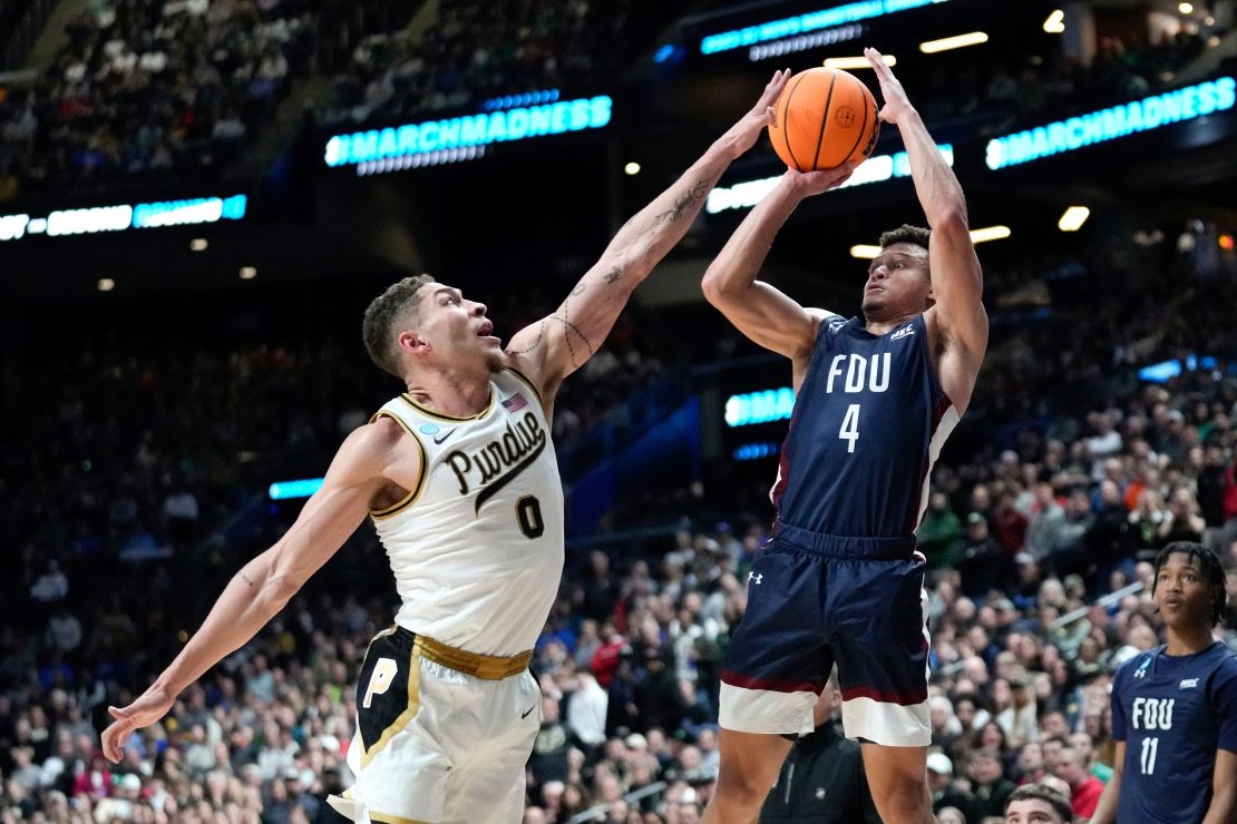 Fairleigh Dickinson guard Grant Singleton (4) shoots on Purdue forward Mason Gillis (0) in the second half of a first-round college basketball game in the NCAA Tournament Friday, March 17, 2023, in Columbus, Ohio. (AP Photo/Paul Sancya)