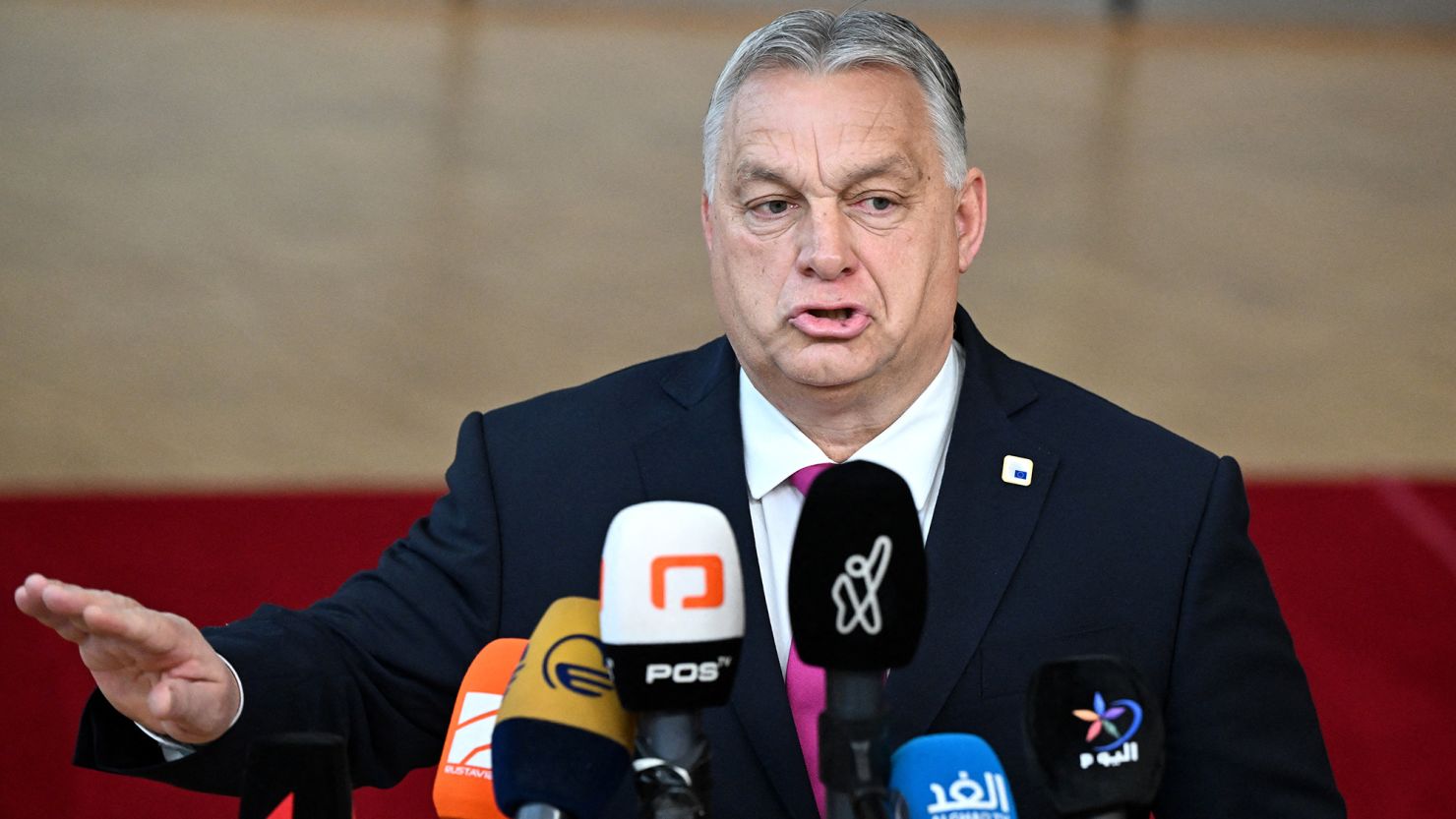 Hungary's Prime Minister Viktor Orban gestures as he talks to the media after arriving at the European headquarters for the EU-Western Balkans summit, in Brussels, on December 14, 2023. EU leaders agreed on December 14, 2023, to open talks with Ukraine on joining the bloc, after Hungarian Prime Minister Viktor Orban ducked out of his threat to veto the plan. The EU's 27 leaders were focused at a crunch summit in Brussels on granting Kyiv a four-year 50-billion-euro ($55-billion) funding package and an agreement to launch formal EU talks for Ukraine on joining the bloc. (Photo by JOHN THYS / AFP) (Photo by JOHN THYS/AFP via Getty Images)