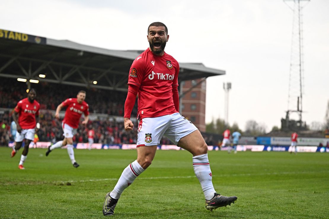Wrexham's English striker Elliot Lee celebrates after scoring their first goal during the English National League football match between Wrexham and Boreham Wood at the Racecourse Ground Stadium in Wrexham, north Wales, on April 22, 2023. (Photo by Oli SCARFF / AFP) (Photo by OLI SCARFF/AFP via Getty Images)