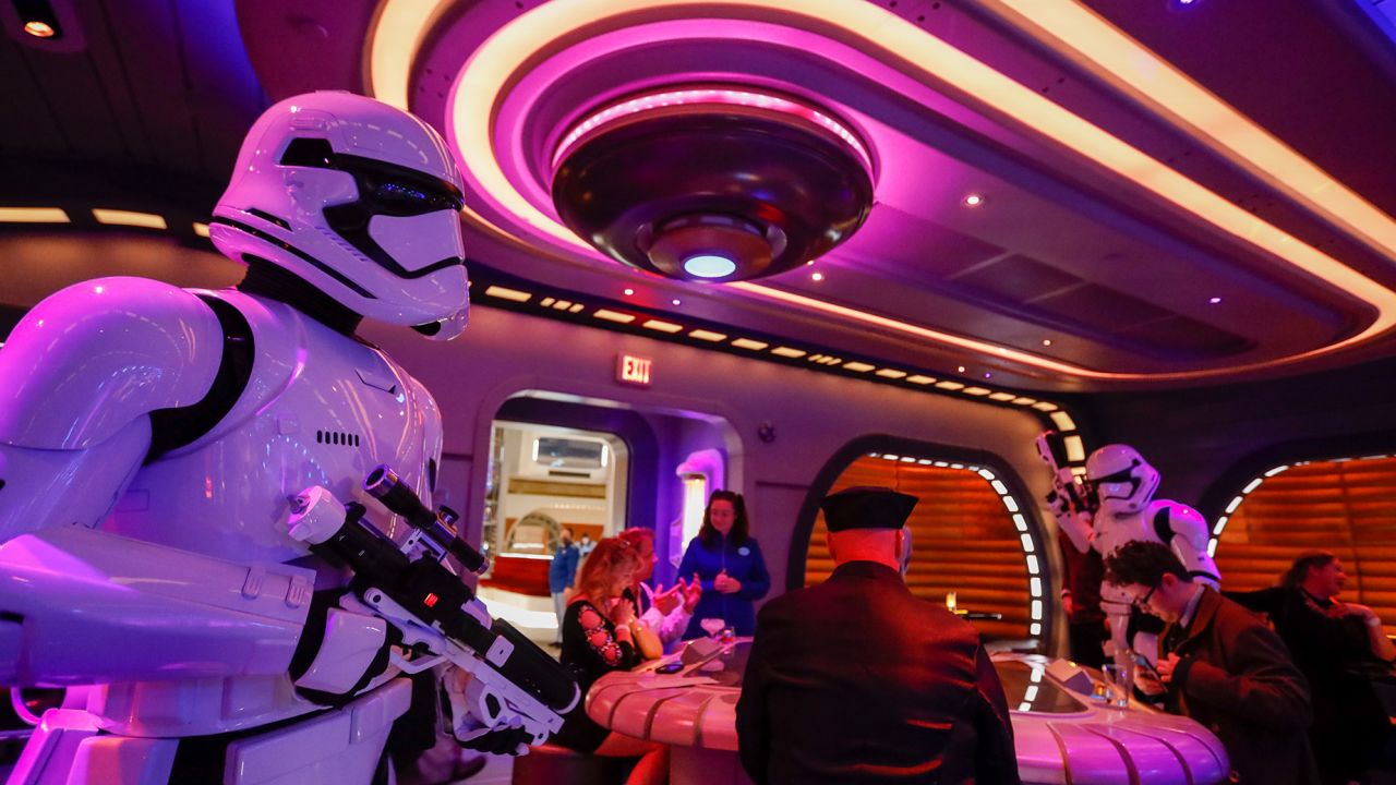 Orlando, Fla - March 01: First Order Stormtroopers patrol through the Sublight Lounge as the first passengers experience the two-day Walt Disney World  Star Wars Galactic Starcruiser, which is a live action role playing game that doubles as a high-end hotel in Orlando, Fla. The event is billed as Halcyons 275th anniversary voyage across the galaxy. at Walt Disney World  Star Wars Galactic Starcruiser in Orlando, Fla on Tuesday, March 1, 2022. First Order lieutenant Harman Croy and his garrison of stormtroopers patrol the ship. Guests arrive at Batuu, a destination for a planet excursion. Players use a data pad to play the immersive game while they participate in activities such as light saber training. (Allen J. Schaben / Los Angeles Times via Getty Images)
