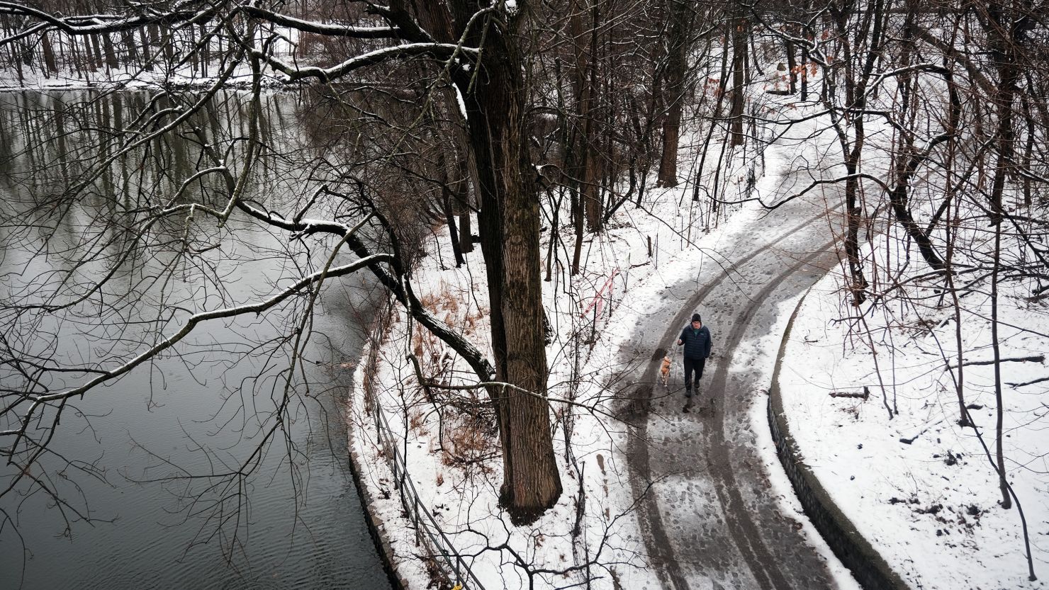 People walk through Brooklyn's Prospect Park on a snowy morning over on February 28, 2023 in New York City.