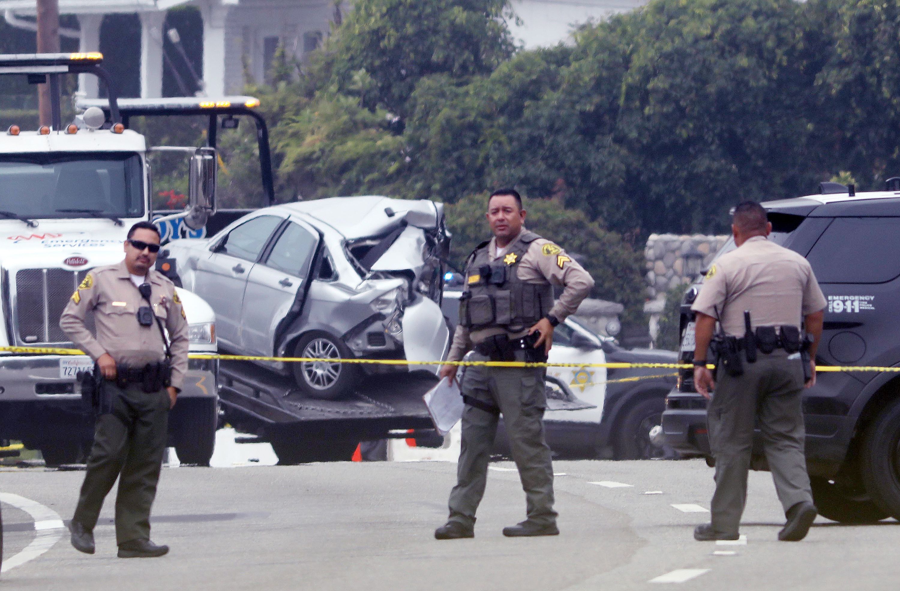 LOS ANGELES, CA - OCTOBER 18, 2023 - Sheriff deputies monitor the scene where four women were killed in a multi-vehicle crash in Malibu on October 18, 2023. A 22-year-old man was arrested after plowing into the pedestrians and parked cars. The crash was reported at 8:30 p.m. Tuesday in the 21600 block of Pacific Coast Highway where they found the victims of the crash, along with the severely damaged vehicles. The crash began when the suspect lost control of his BMW and slammed into multiple parked cars before ricocheting and fatally striking the women, who were standing on the side of the road. (Genaro Molina / Los Angeles Times via Getty Images)