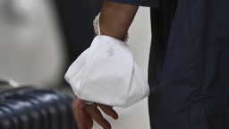 DULLES, VA - SEPTEMBER 8: A passenger wears a face mask around their wrist to protect from the recent uptick in Covid cases at Dulles International Airport on September 8, 2023 in Dulles, Va. (Photo by Ricky Carioti/The Washington Post via Getty Images)