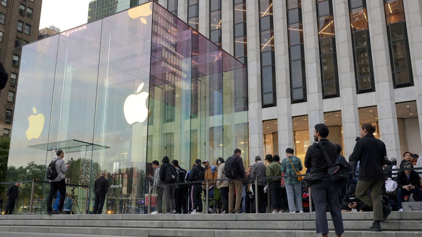 Shoppers wait in line outside the Apple Fifth Avenue store in New York, US, on Friday, Sept. 22, 2023. Apple Inc.'s latest iPhones and watches went on sale Friday, a test of whether a new smartphone design and modest smartwatch changes can help return the company to growth. Photographer: Gabby Jones/Bloomberg via Getty Images