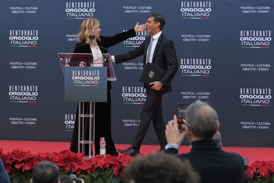 Italy's Prime Minister, Giorgia Meloni welcomes British Prime Minister Rishi Sunak on stage during the Atreju political meeting organised by the young militants of Italian right wing party Brothers of Italy (Fratelli d'Italia) on December 16, 2023 at the Sant'Angelo castle in Rome.
