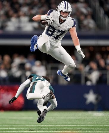 Dallas Cowboys tight end Jake Ferguson leaps over Philadelphia Eagles cornerback Kelee Ringo during the Cowboys' 33-13 victory on December 10. With the win, the Cowboys extended their home winning-streak to 15 games.