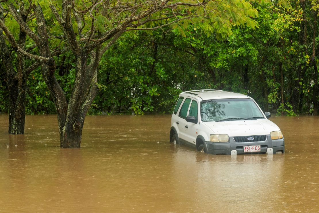 A car inundated with water near the Barron River in Cairns, Australia, Saturday, Dec. 16, 2023.