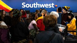 Travelers wait in line at the Southwest Airlines ticketing counter at Nashville International Airport after the airline canceled thousands of flights in Nashville, Tennessee, on December 27, 2022.
