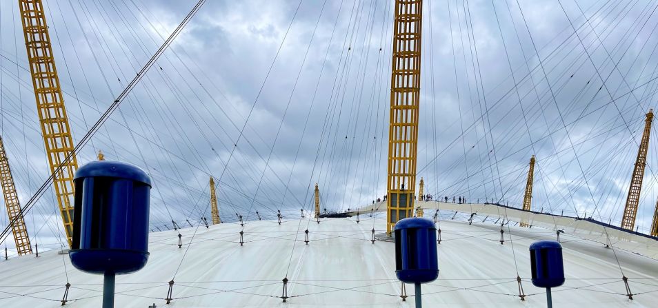 UK-based Alpha 311 has created small wind turbines made from carbon fiber, capable of generating electricity from the energy created by passing cars. Here, an older version of the design is shown installed on the roof of London's O2 Arena.