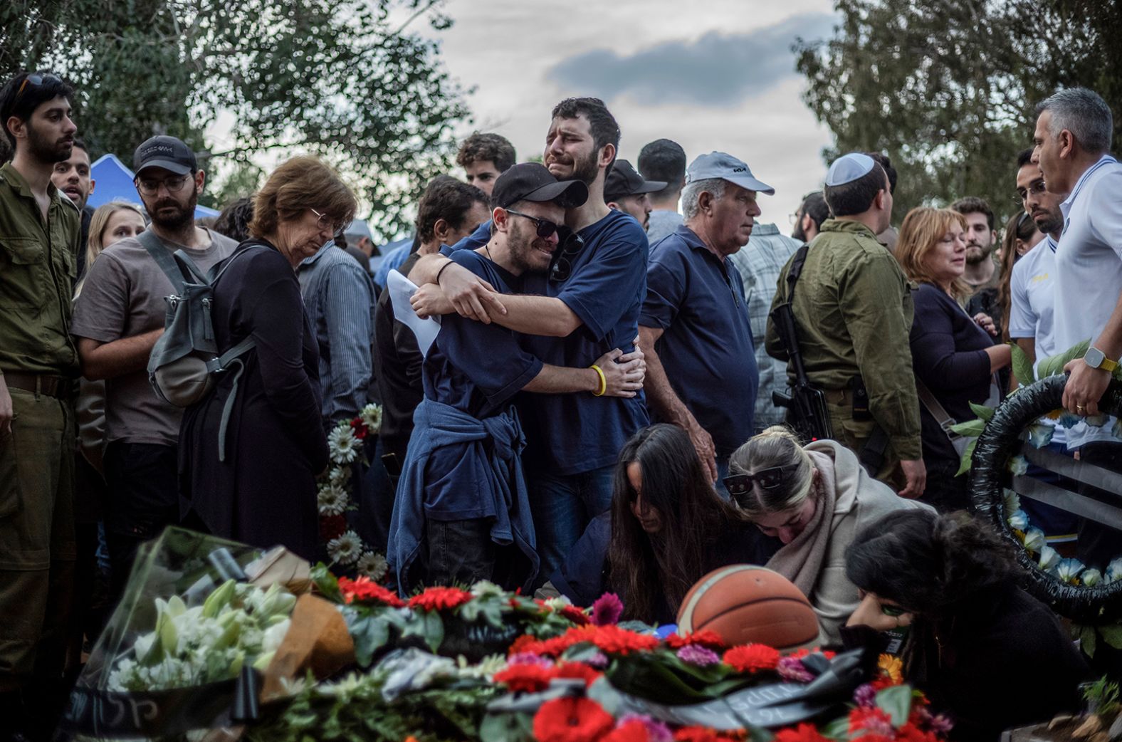 Relatives and friends of Alon Lulu Shamriz, one of the 3 Israeli hostages who were mistakenly killed by friendly fire, mourn during his funeral in Shefayim, Israel on December 17.