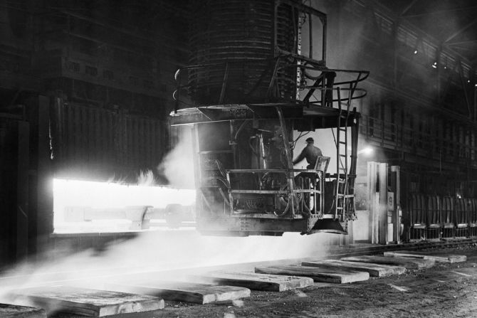 A man in a crane charges slabs of iron at the Gary Works plant in Gary, Indiana, in 1945. Gary Works, US Steel's largest manufacturing plant, was the largest steel mill in the world for most of the 20th century, <a href="https://chicago.suntimes.com/columnists/2023/10/24/23929058/steel-mill-pollution-environment-toll-gary-indiana-biden-infrascture-clean-energy-ben-jealous" target="_blank" target="_blank">according to the Chicago Sun-Times</a>.