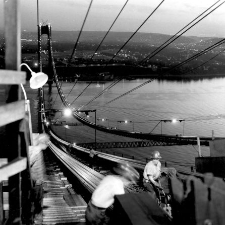 Workers toil around the clock to complete the installation of the main support cables of the Verrazzano-Narrows Bridge in New York in 1963.