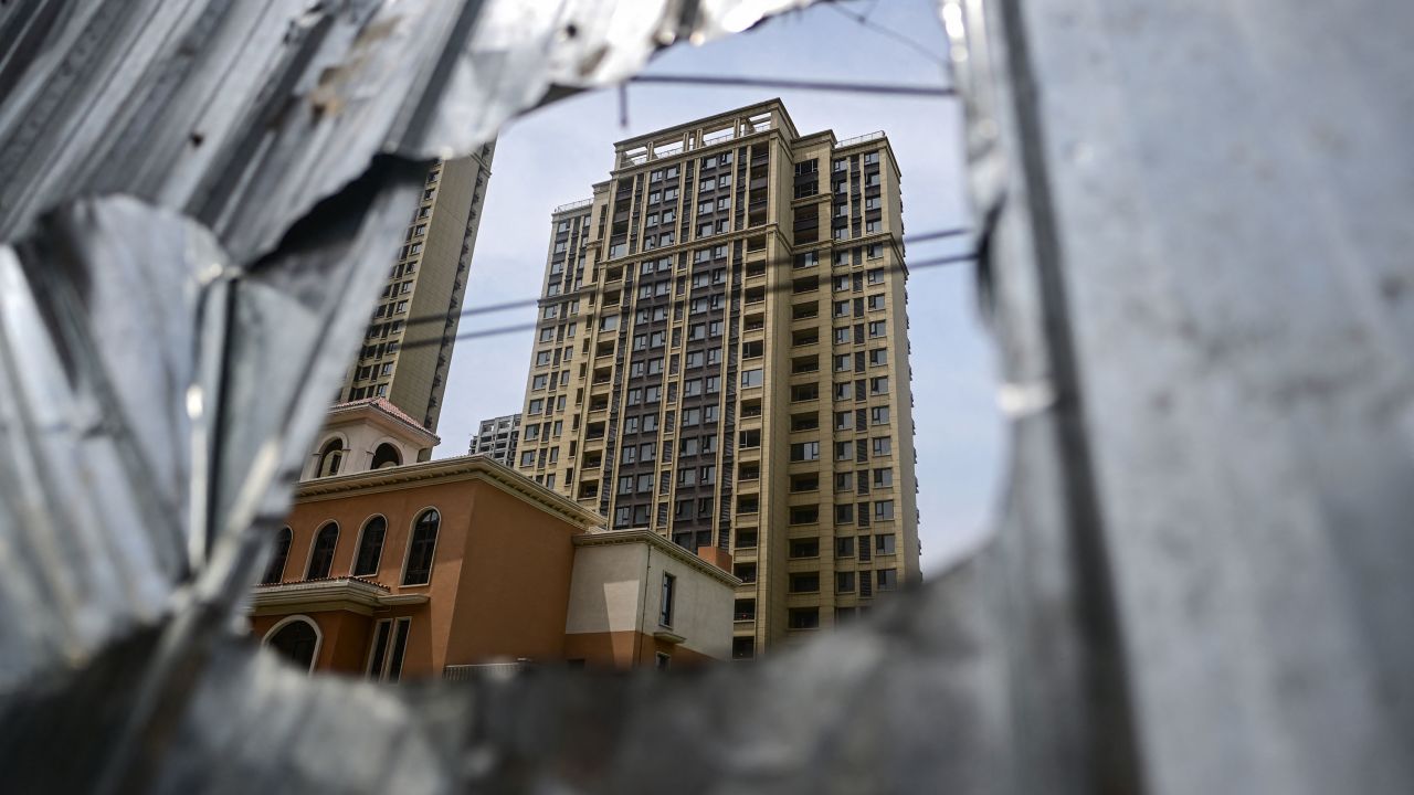 This photo taken on June 20, 2023 shows a view of a complex of unfinished apartment buildings in Xinzheng City in Zhengzhou, China's central Henan province. China's real estate industry grew at lightning speed from the late 90s, and was a major component of the country's turbocharged economic expansion. But with growth slowing and debts swelling, authorities cut off access to easy loans in 2020, pummelling the sector and causing a record-breaking slump last year. 
A wave of mortgage boycotts spread nationwide last summer, as cash-strapped developers struggled to raise enough to complete homes they had already sold in advance -- a common practice in China. (Photo by Pedro PARDO / AFP) (Photo by PEDRO PARDO/AFP via Getty Images)