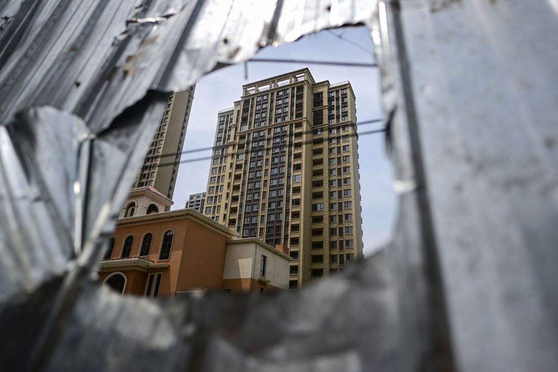 This photo taken on June 20, 2023 shows a view of an unfinished apartment complex in Xinzheng, Zhengzhou, central Henan province, China. China's real estate industry has grown at lightning speed since the late 1990s and became a key component of the country's rapid economic expansion. But as growth slowed and debt soared, authorities cut off access to easy loans in 2020, hurting the sector and sparking a record recession last year. This comes after a wave of mortgage boycotts spread across the country last summer as cash-strapped developers struggled to raise enough money to complete homes they had already pre-sold. This is a common practice in China.  (Photo Credit: Pedro PARDO/AFP) (Photo Credit: PEDRO PARDO/AFP, Getty Images)