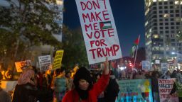 LOS ANGELES, CALIFORNIA - DECEMBER 8: A woman holds a sign suggesting that she might now vote for Donald Trump for president as protesters march in the street to denounce the Biden administration's support of Israel, which has killed thousands of Palestinian civilians so far in its war against Hamas in Gaza, on December 8, 2023 in Los Angeles, California. U.S. President Joe Biden and first lady Jill Biden plan to attend six fundraising events and meetings between them in the Los Angeles area over the weekend. More than 17,487 Palestinians, including more than 6,600 children, are reported to have been killed by Israeli forces in Gaza since the Palestinian group Hamas attacked Israel, killing approximately 1,200 on October 7. After a several day cease fire to exchange hostages and prisoners, the Israel Defense Forces (IDF) have resumed its bombing and ground fighting, now intensifying in southern Gaza after weeks of warning people to flee there to escape Israeli bombing in the north.  (Photo by David McNew/Getty Images)