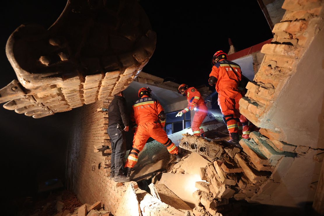 Rescue workers search a house for survivors after an earthquake in Kangdiao village, Dahejia, Jishishan County, in northwest China's Gansu province on December 19, 2023.
