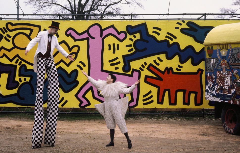 And here, performers pose in front of a mural Haring also contributed to Luna Luna. © Keith Haring Foundation/licensed by Artestar, New York. 