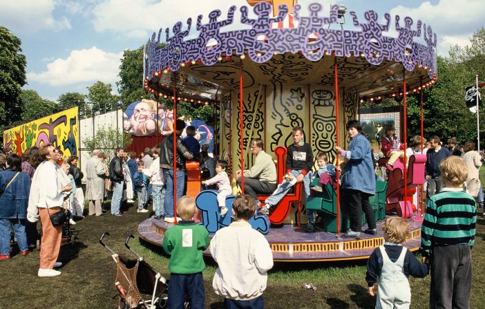 Visitors ride Haring's painted carousel. © Keith Haring Foundation/licensed by Artestar, New York.