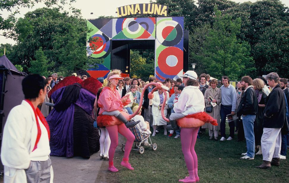 Performers — dressed as jockeys riding flamingos, naturally — entertain crowds in front of the Sonia Delaunay-designed archway at the entrance to Luna Luna.