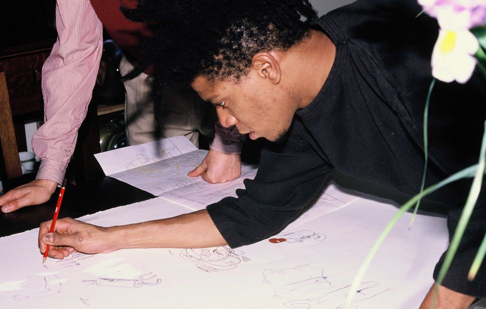 Here, Basquiat is pictured sketching designs for his Ferris wheel. © Estate of Jean-Michel Basquiat/licensed by Artestar, New York. 