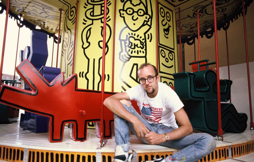 The artist Keith Haring poses with his painted carousel. © Keith Haring Foundation/licensed by Artestar, New York. 