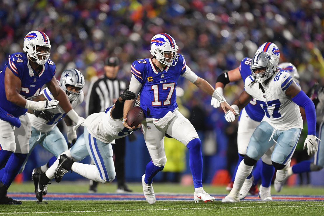 Buffalo Bills quarterback Josh Allen (17) carries the ball against the Dallas Cowboys during the second quarter of an NFL football game, Sunday, Dec. 17, 2023, in Orchard Park, N.Y. (AP Photo/Adrian Kraus)