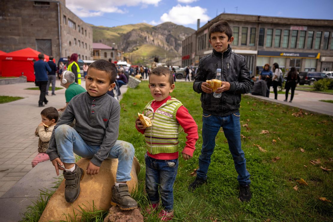 09/27/2023 Goris, Armenia. Kids are playing in front of the registration center while their parents are waiting in the line of registration. (Photo by Anthony Pizzoferrato / Middle East Images / Middle East Images via AFP) (Photo by ANTHONY PIZZOFERRATO/Middle East Images /AFP via Getty Images)