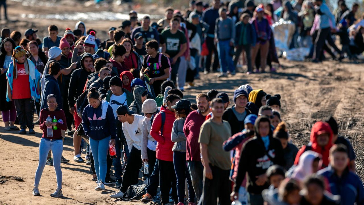 EAGLE PASS, TEXAS - DECEMBER 18: More than 1,000 migrants wait in line to be processed by U.S. Border Patrol agents after crossing the Rio Grande from Mexico on December 18, 2023 in Eagle Pass, Texas. A surge as many as 12,000 immigrants per day crossing the U.S. southern border has overwhelmed U.S. immigration authorities in recent weeks. (Photo by John Moore/Getty Images)