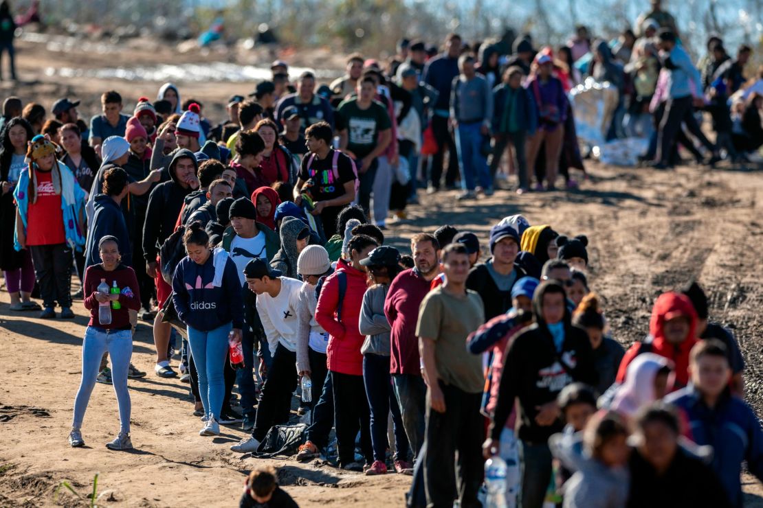 EAGLE PASS, TEXAS - DECEMBER 18: More than 1,000 migrants wait in line to be processed by U.S. Border Patrol agents after crossing the Rio Grande from Mexico on December 18, 2023 in Eagle Pass, Texas. A surge as many as 12,000 immigrants per day crossing the U.S. southern border has overwhelmed U.S. immigration authorities in recent weeks. (Photo by John Moore/Getty Images)
