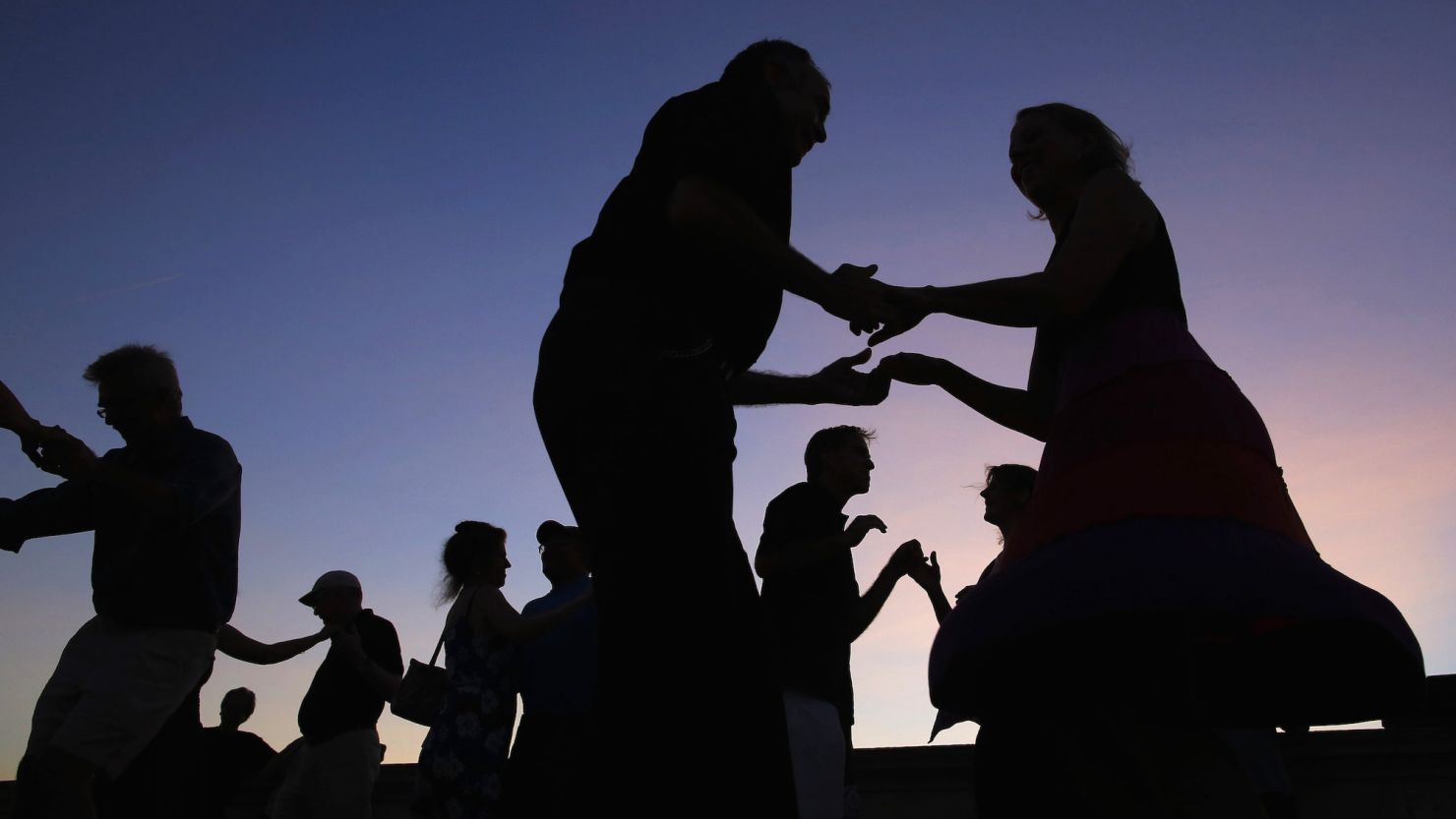 Couples dance during one of the Tango Society of Boston's Tango by Moonlight evenings on the Weeks Footbridge over the Charles River in Cambridge, Massachusetts July 6, 2013.  This is the society's 17th Tango by Moonlight season.    REUTERS/Brian Snyder  (UNITED STATES - Tags: SOCIETY)