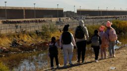 Migrants, seeking asylum in the United States stand on the banks of the Rio Bravo river at the border between the U.S. and Mexico, as seen from Ciudad Juarez, Mexico, December 18, 2023. REUTERS/Jose Luis Gonzalez