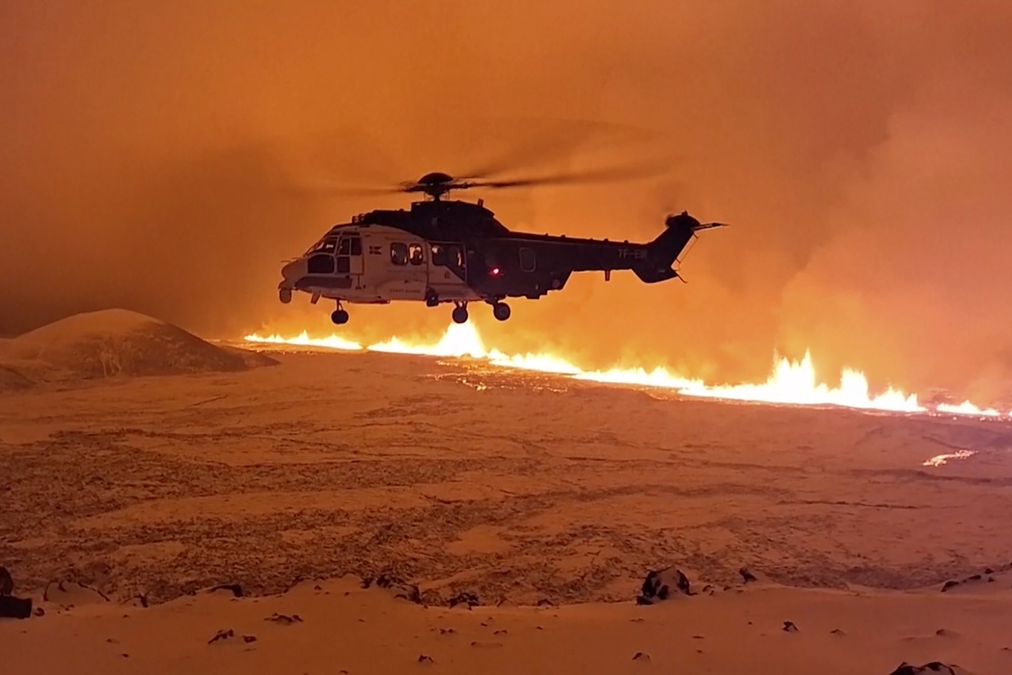 This image made from video provided by the Icelandic Coast Guard shows its helicopter flying near to magma.