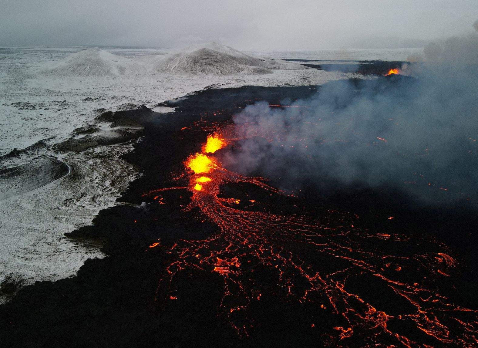 A drone picture shows lava spewing from the site of the volcanic eruption north of Grindavik, on December 19.