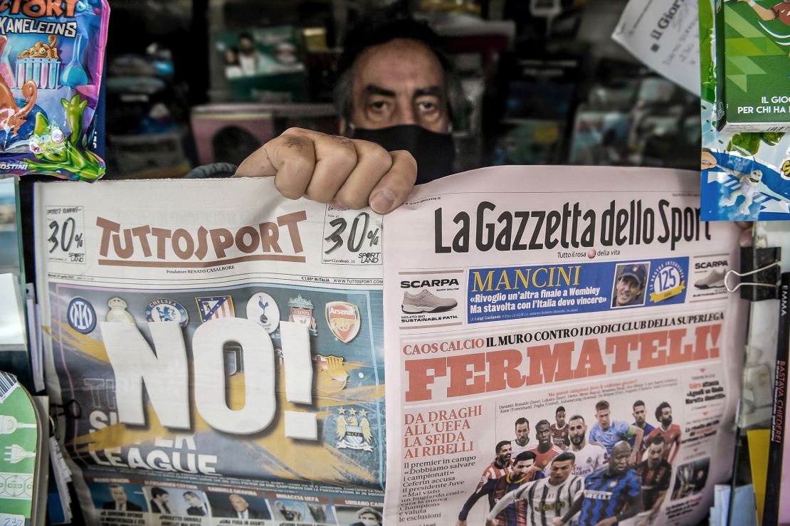 LIVORNO, ITALY - APRIL 20:  A newsagent shows two pages of the main Italian sports newspapers with a headline regarding the Super League reading 'No!' and 'Fermateli!' ('Stop them!) on April 20, 2021 in Livorno, Italy. There are three Italian teams at the moment that would participate in the European Super League, Juventus, AC Milan and Inter. At the moment the 12 clubs, called 'scissionisti' (splinters) in Italy, have jointly announced an agreement for a new football competition, the Super League, governed by the Founding Clubs: AC Milan, Arsenal FC, Atlético de Madrid, Chelsea FC, FC Barcelona, FC Internazionale Milano, Juventus FC, Liverpool FC, Manchester City, Manchester United, Real Madrid CF and Tottenham Hotspur. In a statement released last night, the new competition "is intended to commence as soon as practicable" potentially in August.  (Photo by Laura Lezza/Getty Images)